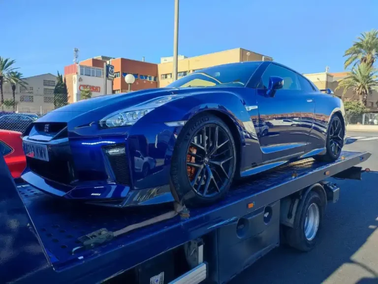 Grúa de plataforma transportando un coche